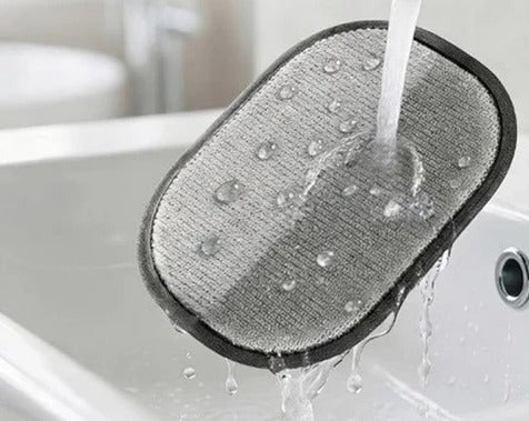 The Furvia glove being rinsed clean under a running tap